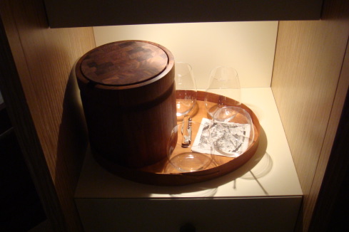 a wooden tray with glasses and a bucket on it