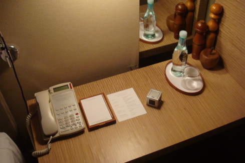 a desk with a telephone and papers