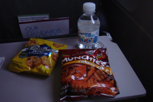 a bottle of water next to a bag of chips