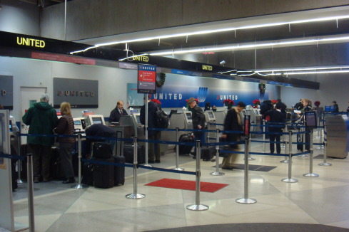 people standing in a line at an airport