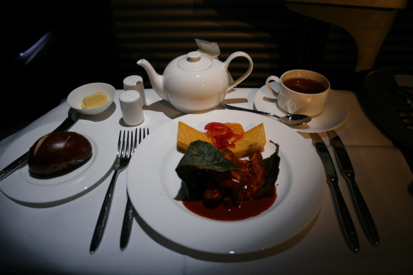 a plate of food and tea set on a table