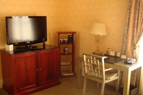 a room with a tv and a desk