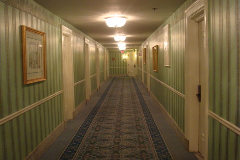 long hallway with green striped walls