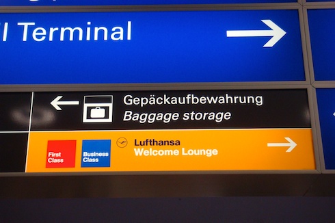 a sign with an arrow pointing to an airport terminal