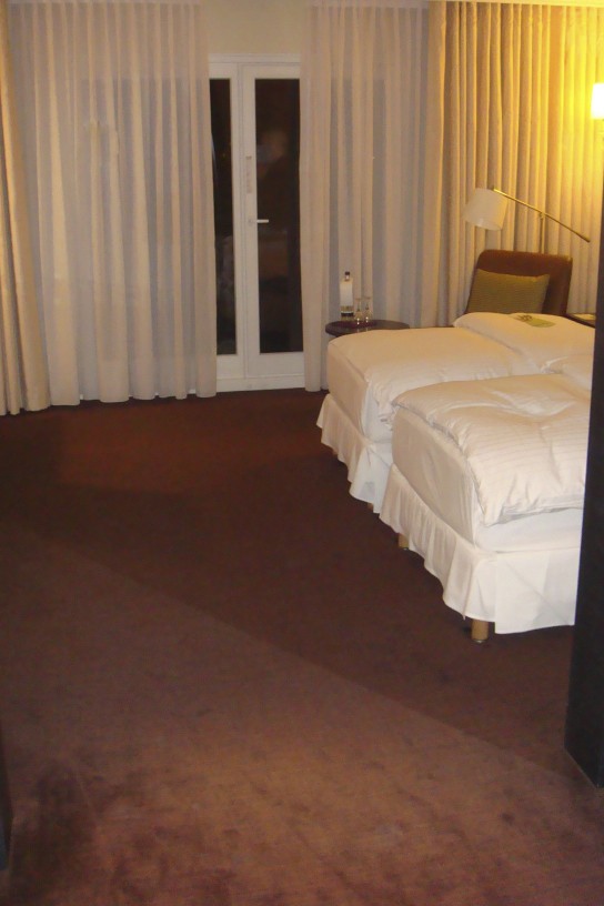a hotel room with white curtains