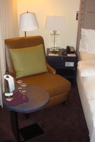 a chair and a table in a hotel room
