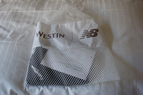 a white mesh bag with a logo on it