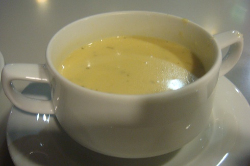 a white cup with yellow liquid in it