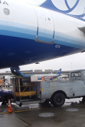 a truck loading a plane