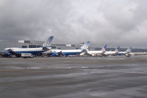 a row of airplanes parked in a row