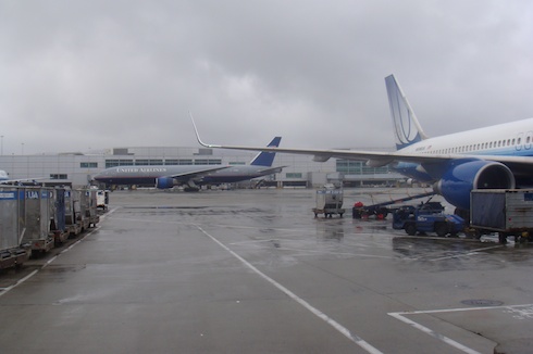 a few airplanes parked at an airport