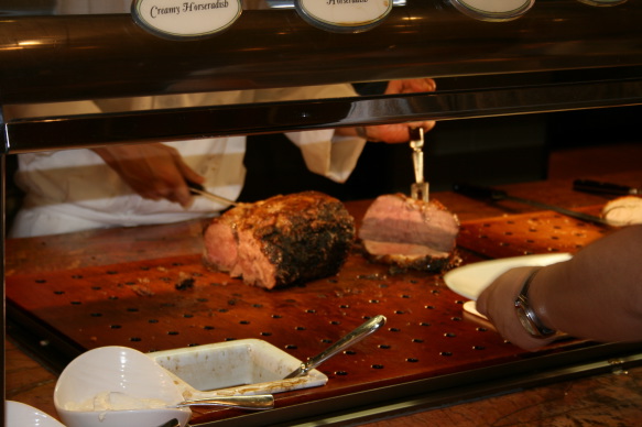 a person cutting meat on a counter