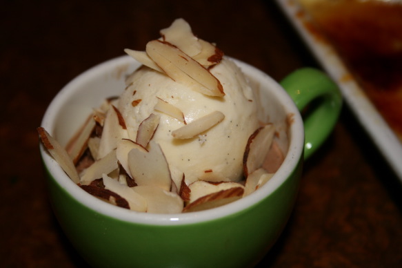 a cup of ice cream with almonds