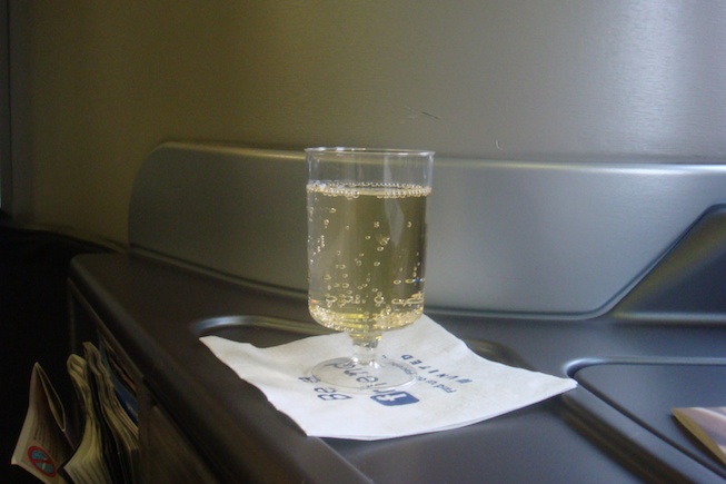 a glass of champagne on a napkin