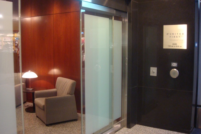 an elevator with a chair and a lamp