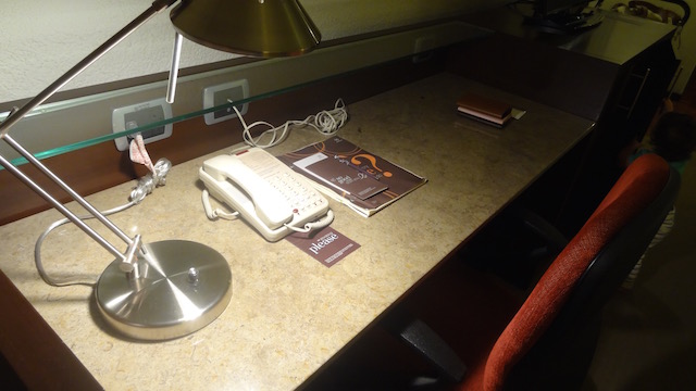 Large desk, landline phone at the center