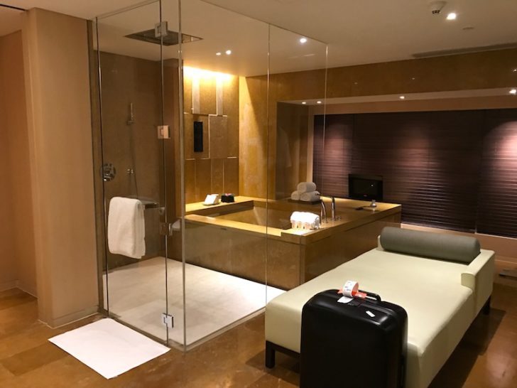 a room with a shower and a bed