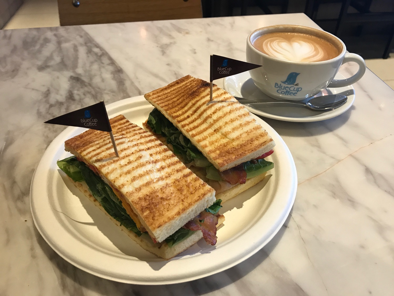 a plate of sandwiches and a cup of coffee