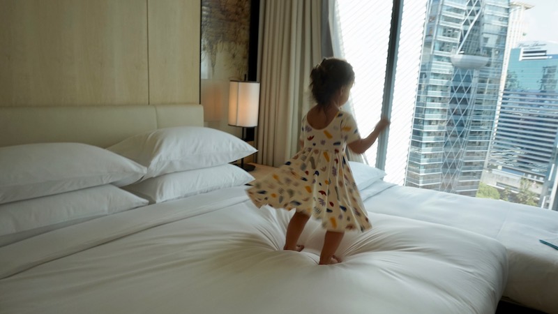 a girl standing on a bed