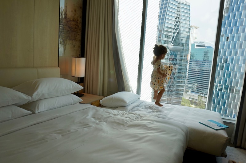 a child jumping on a bed