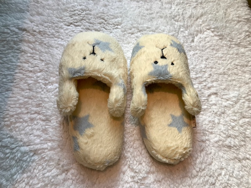 a pair of slippers on a white surface