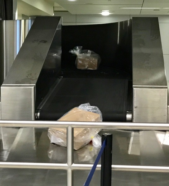 a baggage claim area with a conveyor belt
