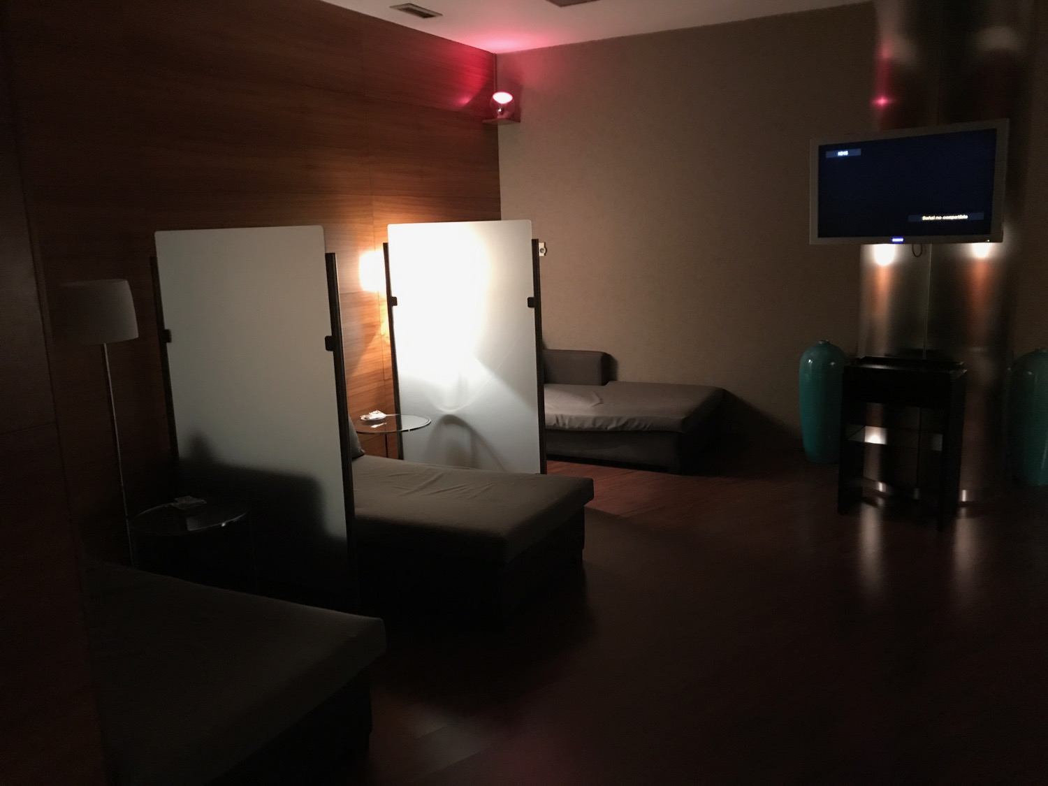 a room with a television and a couple of beds