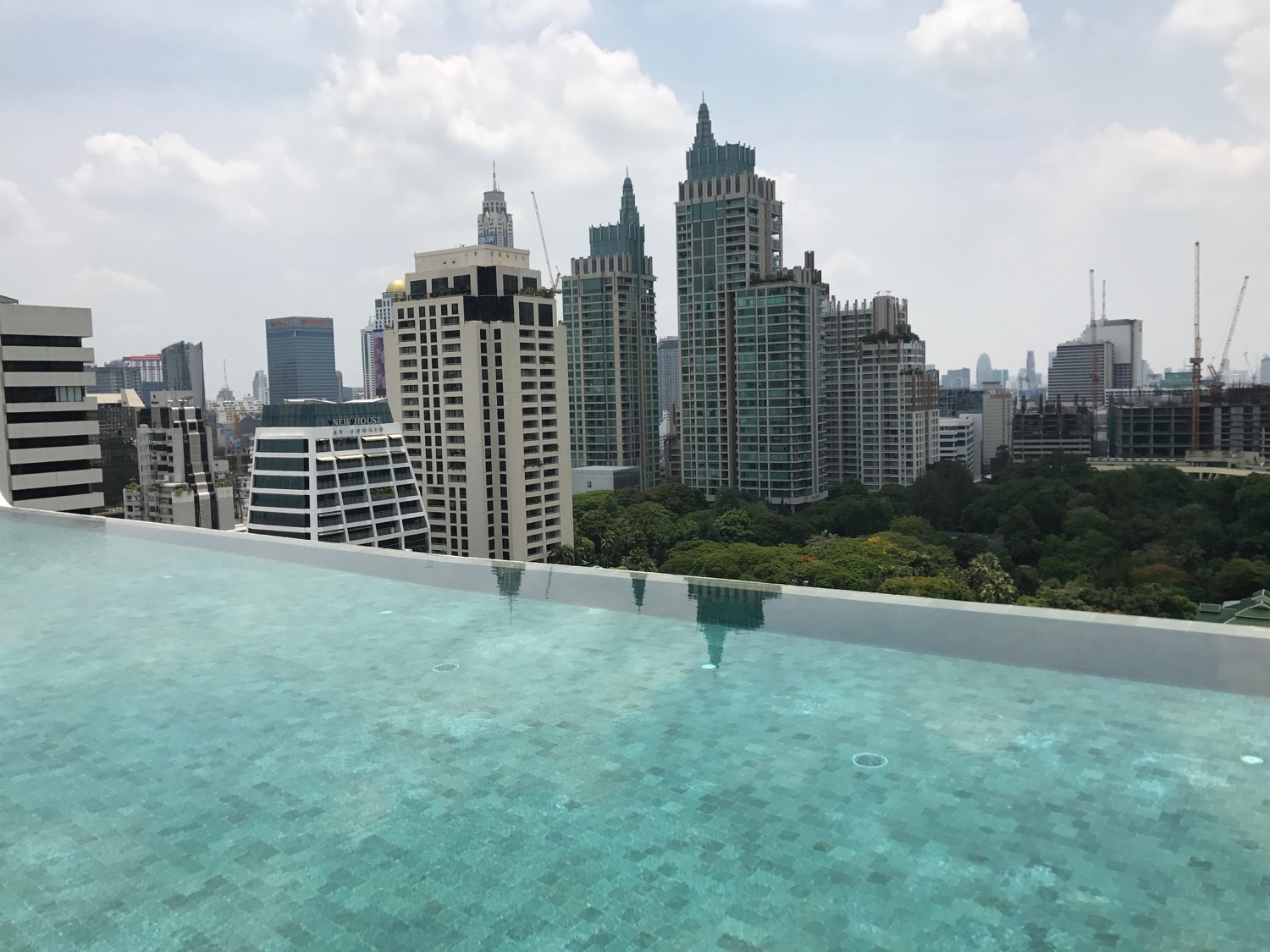 a pool with a city skyline in the background