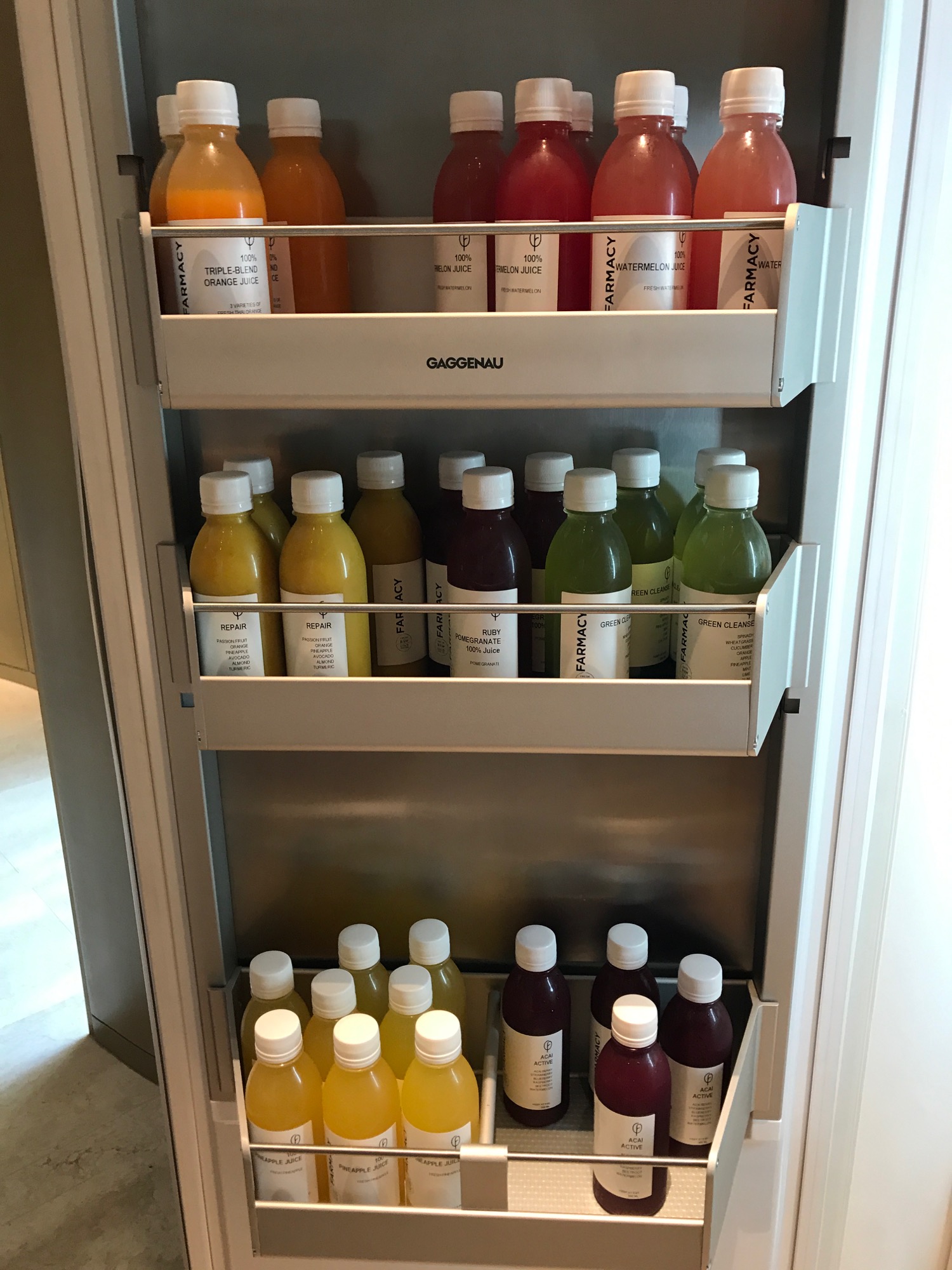 a shelf with bottles of juice