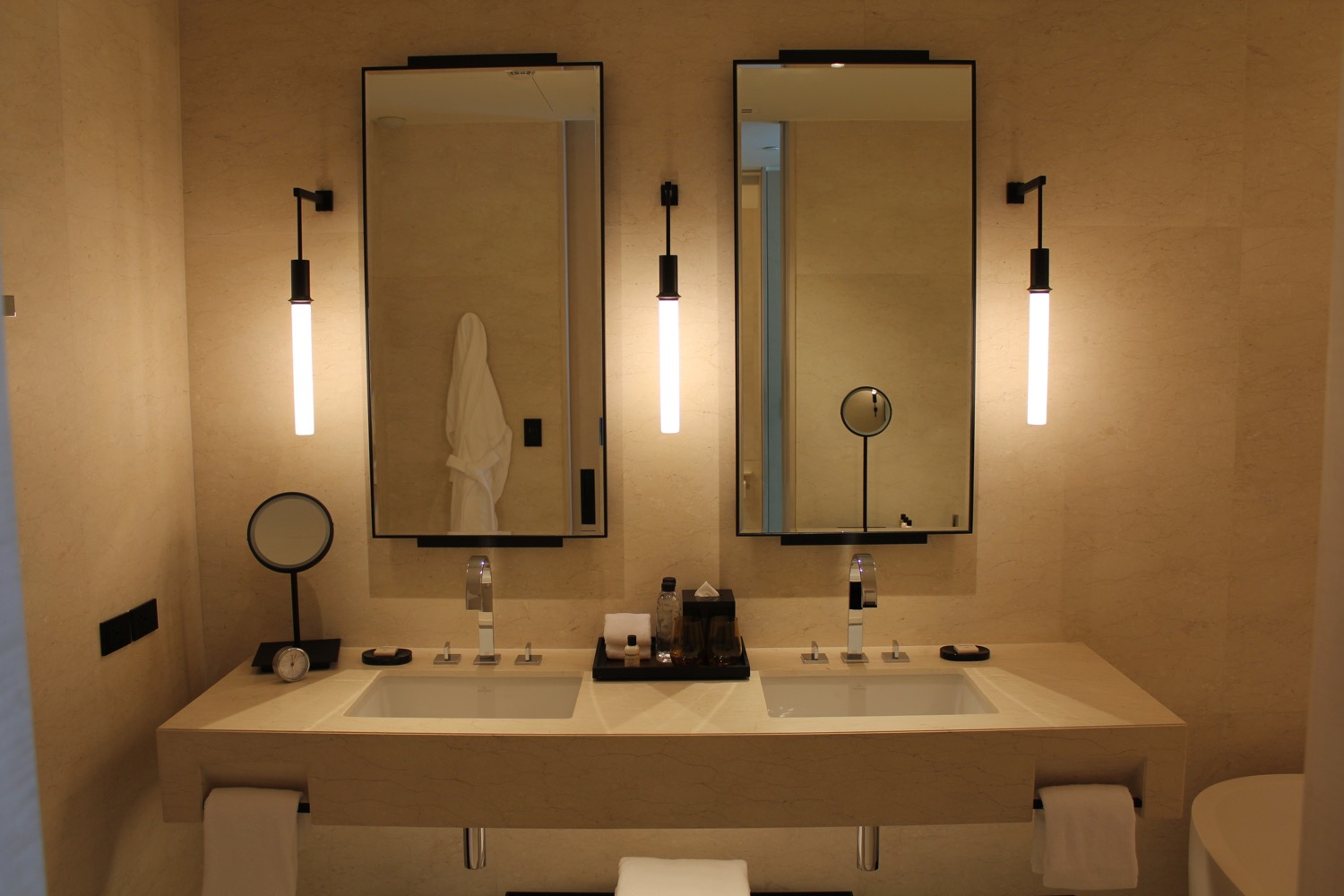 a bathroom with two mirrors and sinks