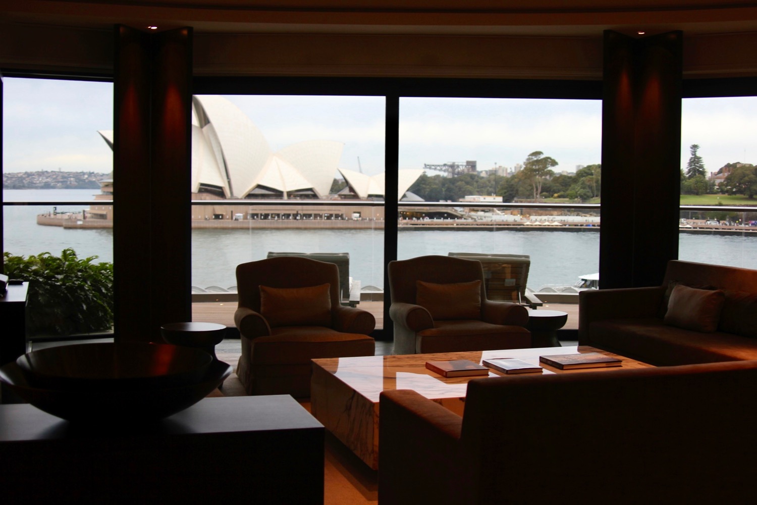 a room with a view of sydney opera house and water