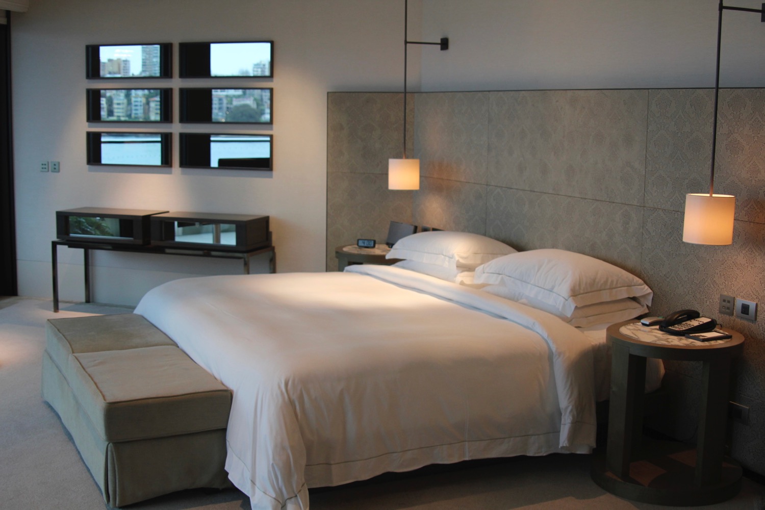 a bed with a large headboard and a lamp