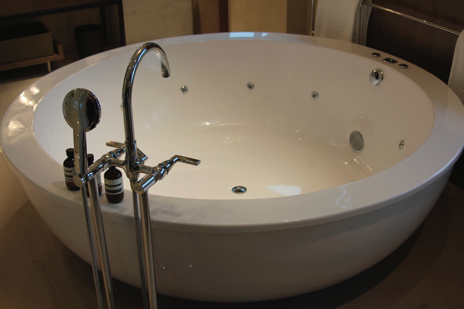 a white bathtub with silver faucets