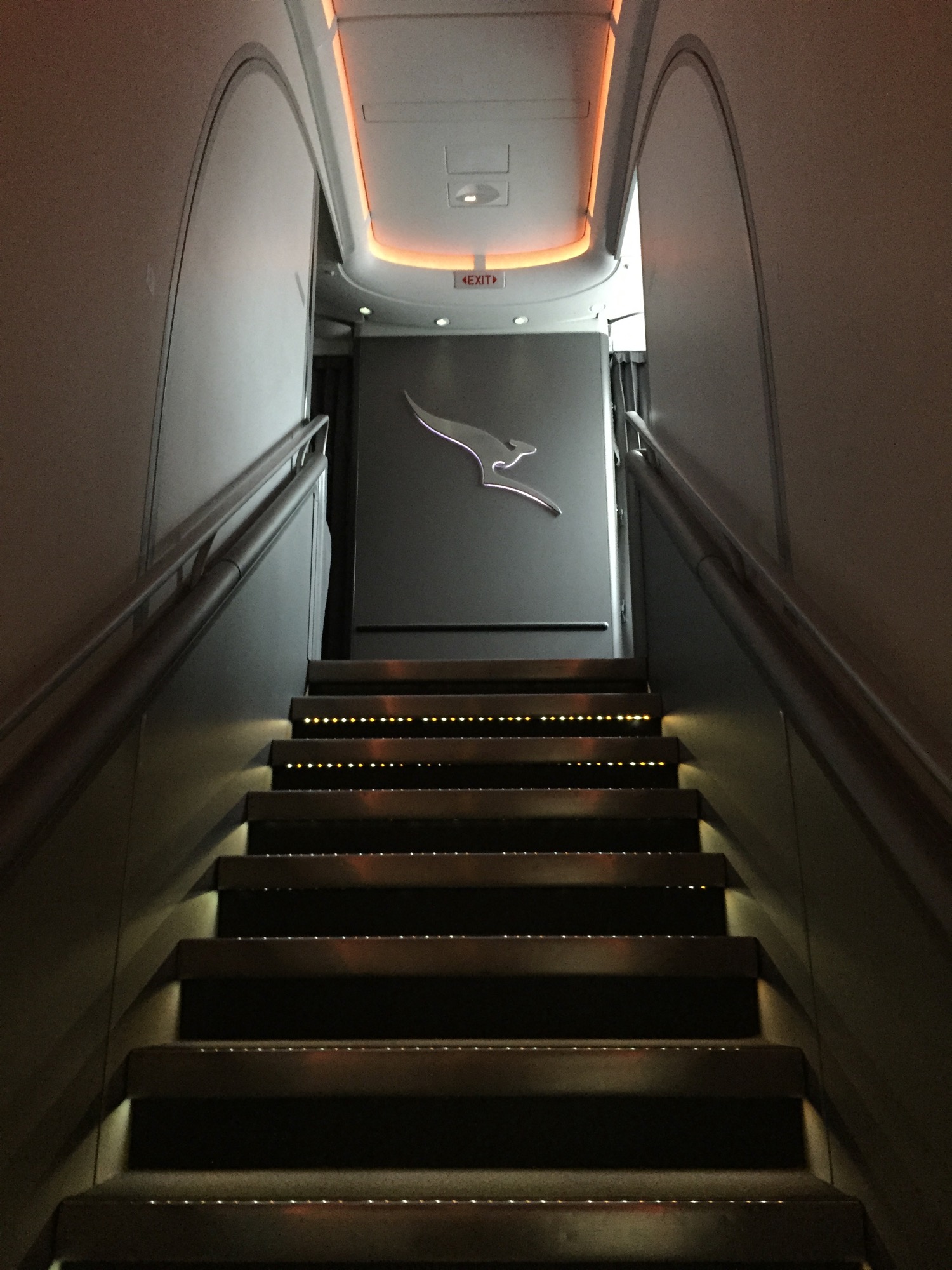 a flight of stairs with a logo on the wall