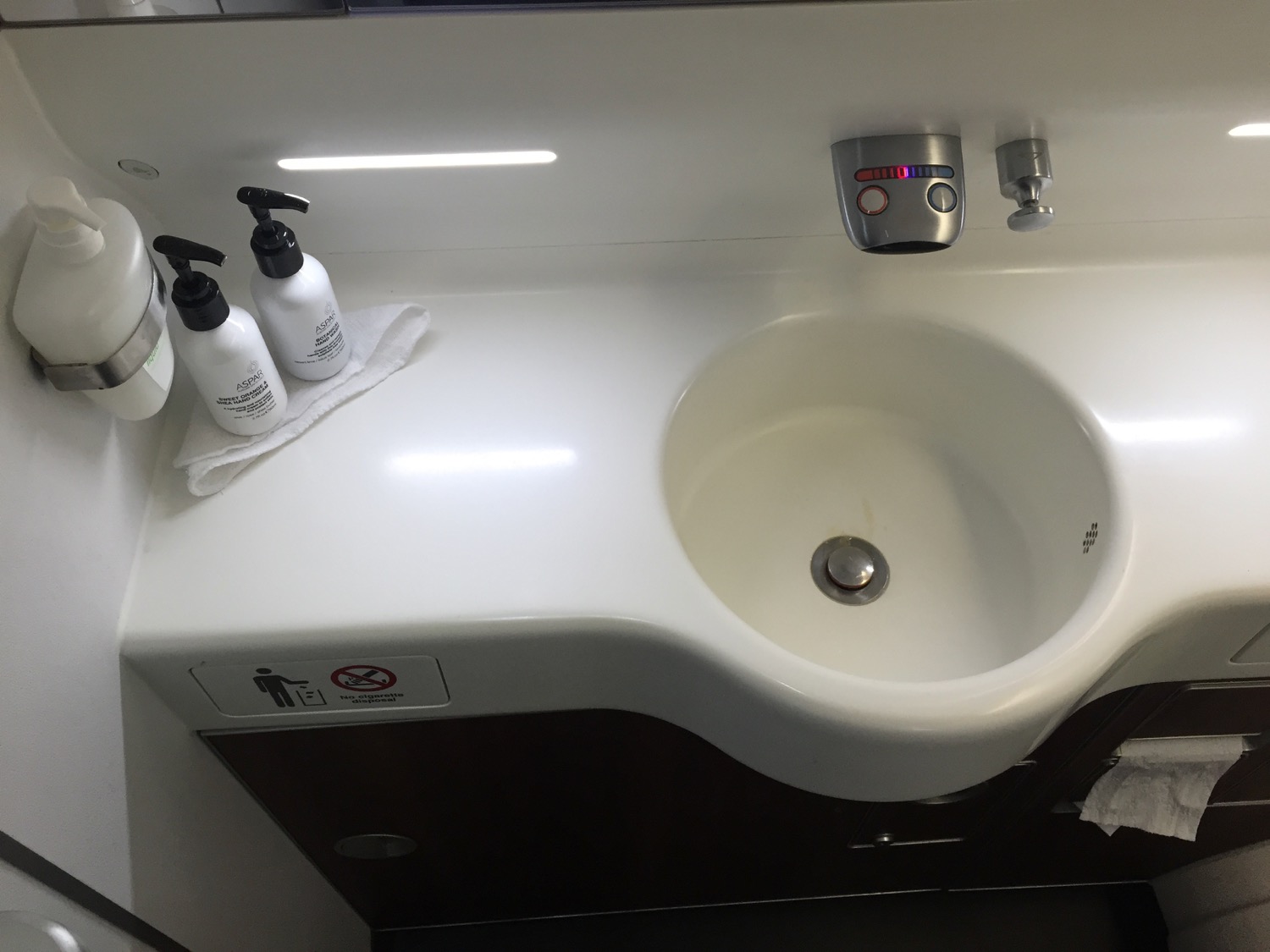 a sink with soap dispensers and bottles on the counter