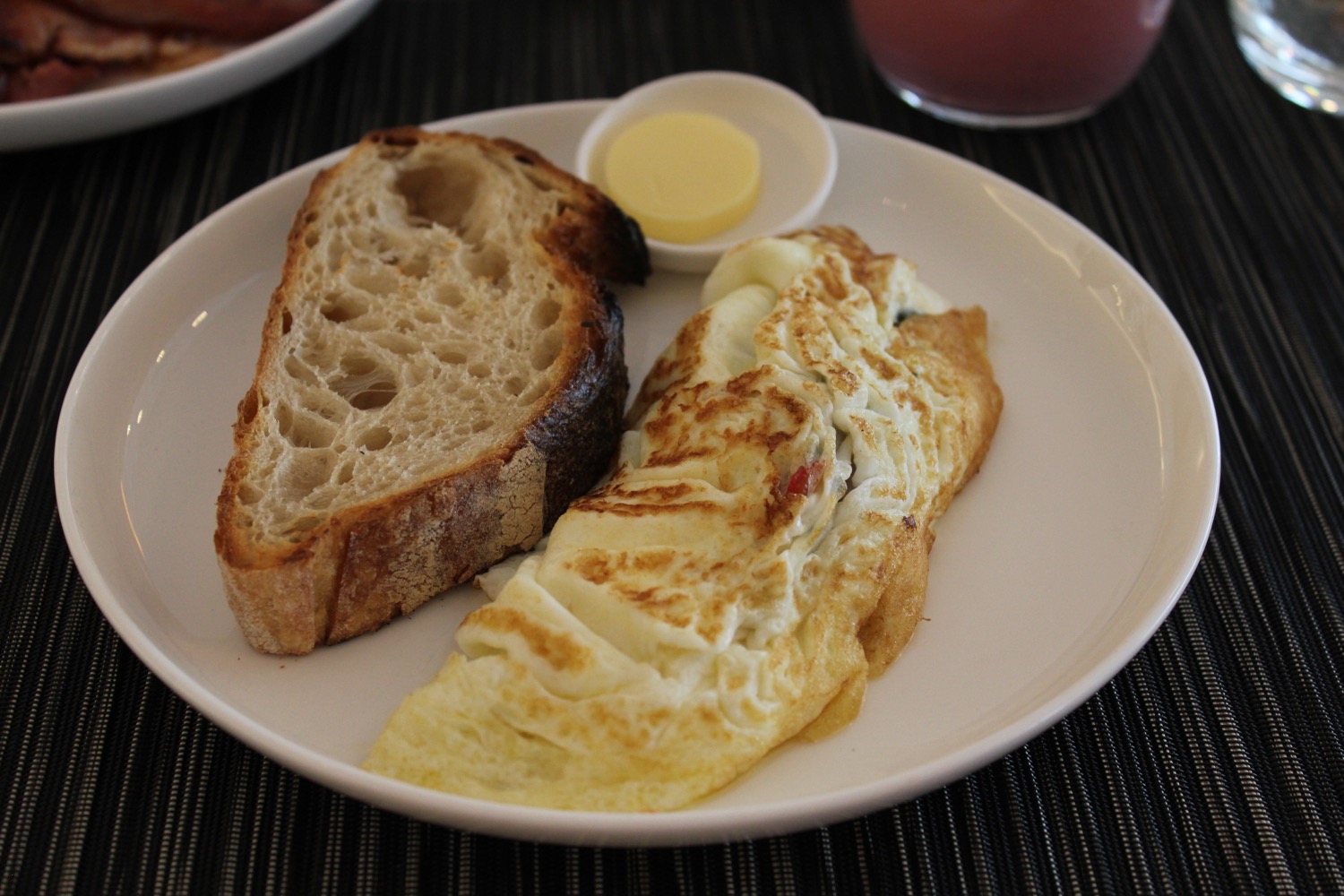 a plate of food with butter and eggs