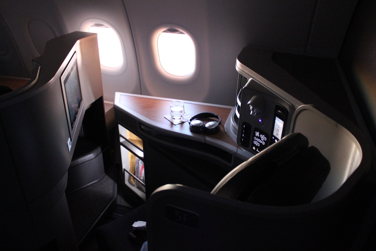 a seat in an airplane with a screen and a monitor