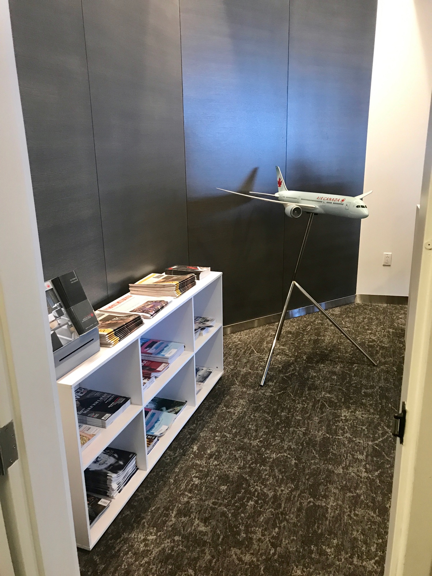 a model airplane on a stand in a room