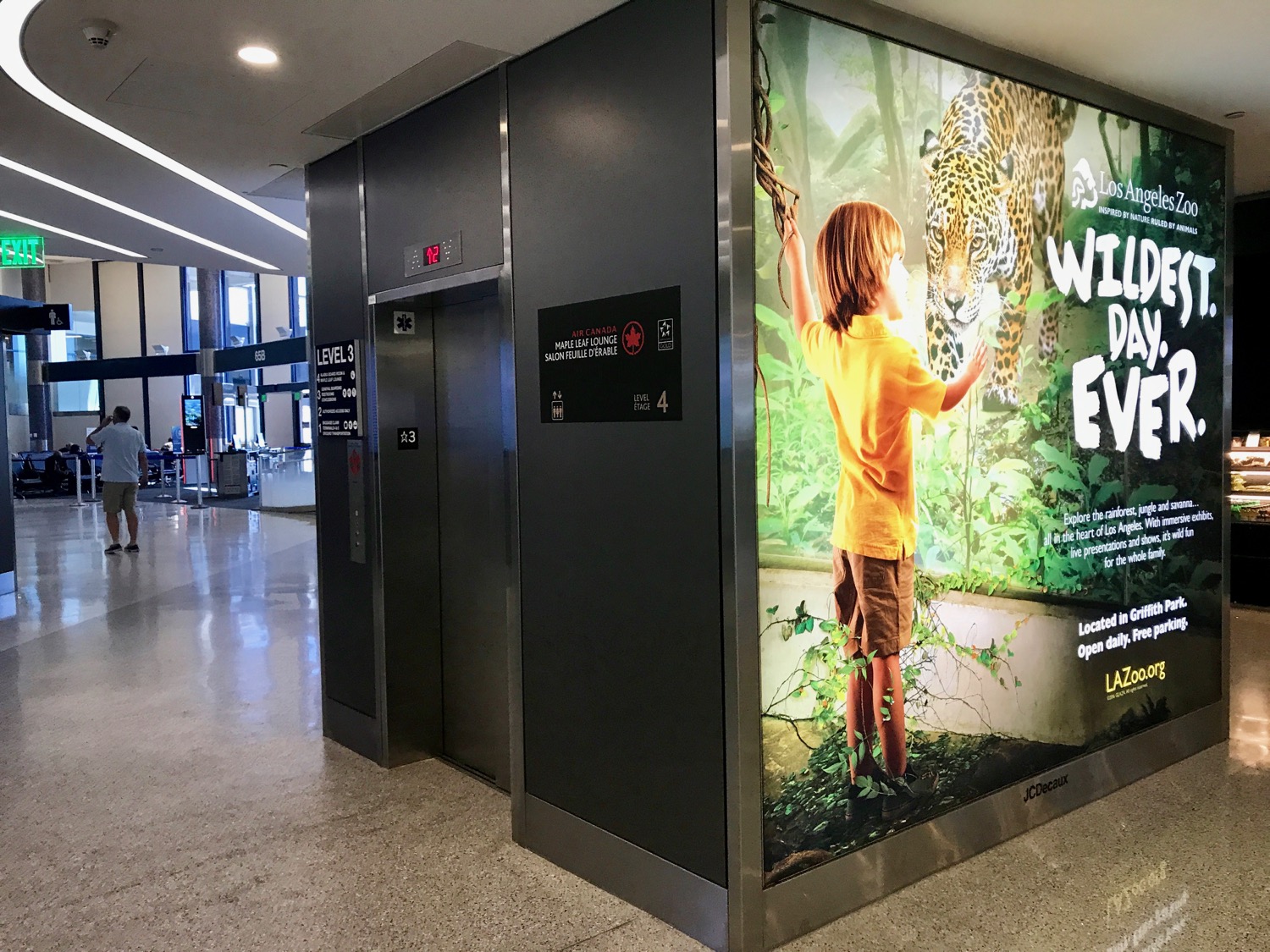 an elevator with an advertisement on the wall
