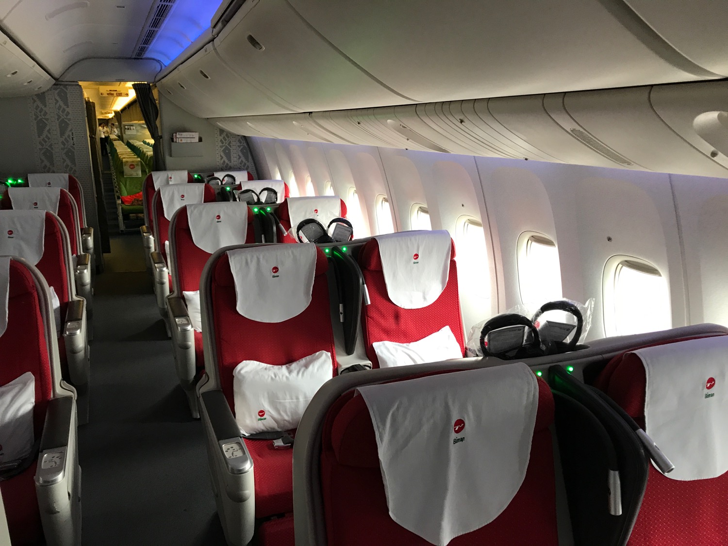 a row of red and white seats on an airplane