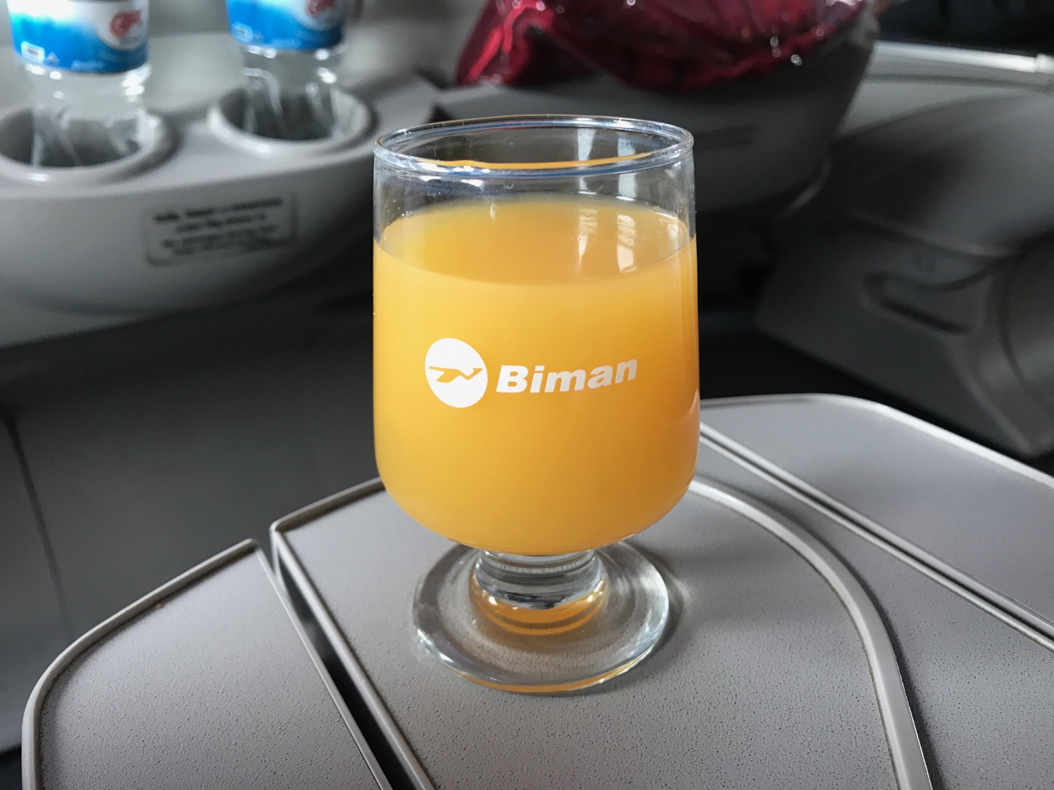 a glass of orange juice on a table