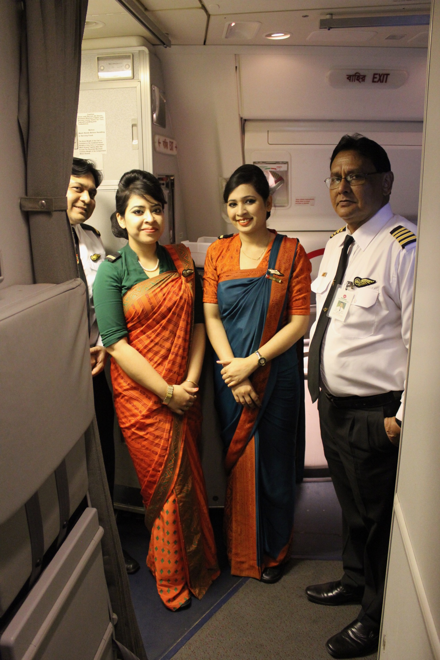 a group of people standing in an airplane