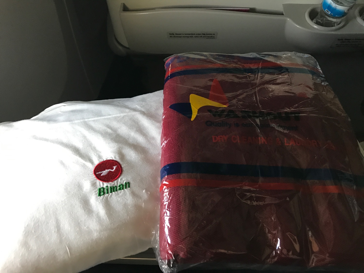 a white towel and a red towel on a plane