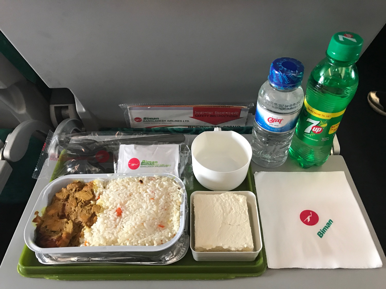 food on a tray with a drink and a napkin