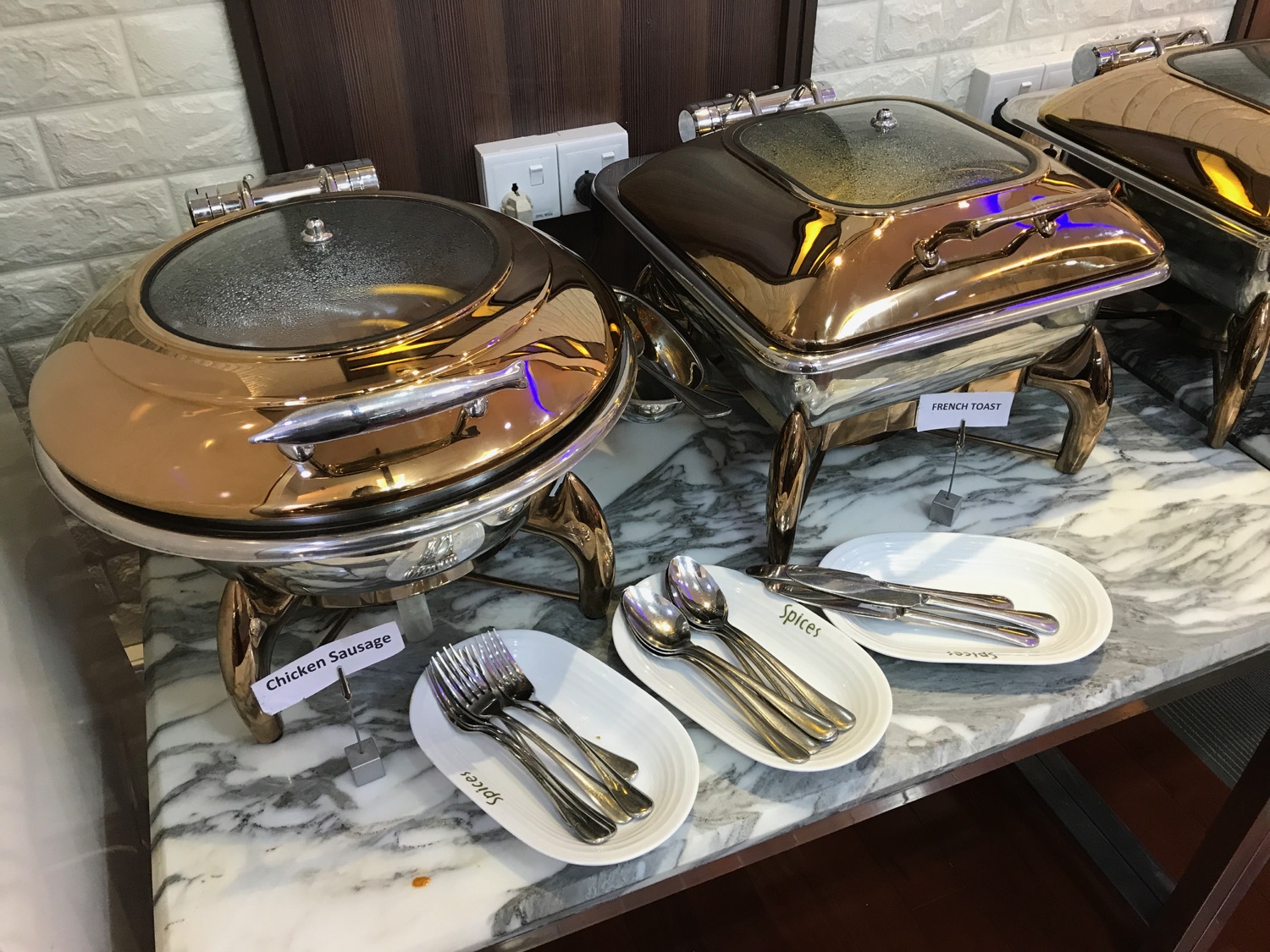 a group of silverware on a marble counter