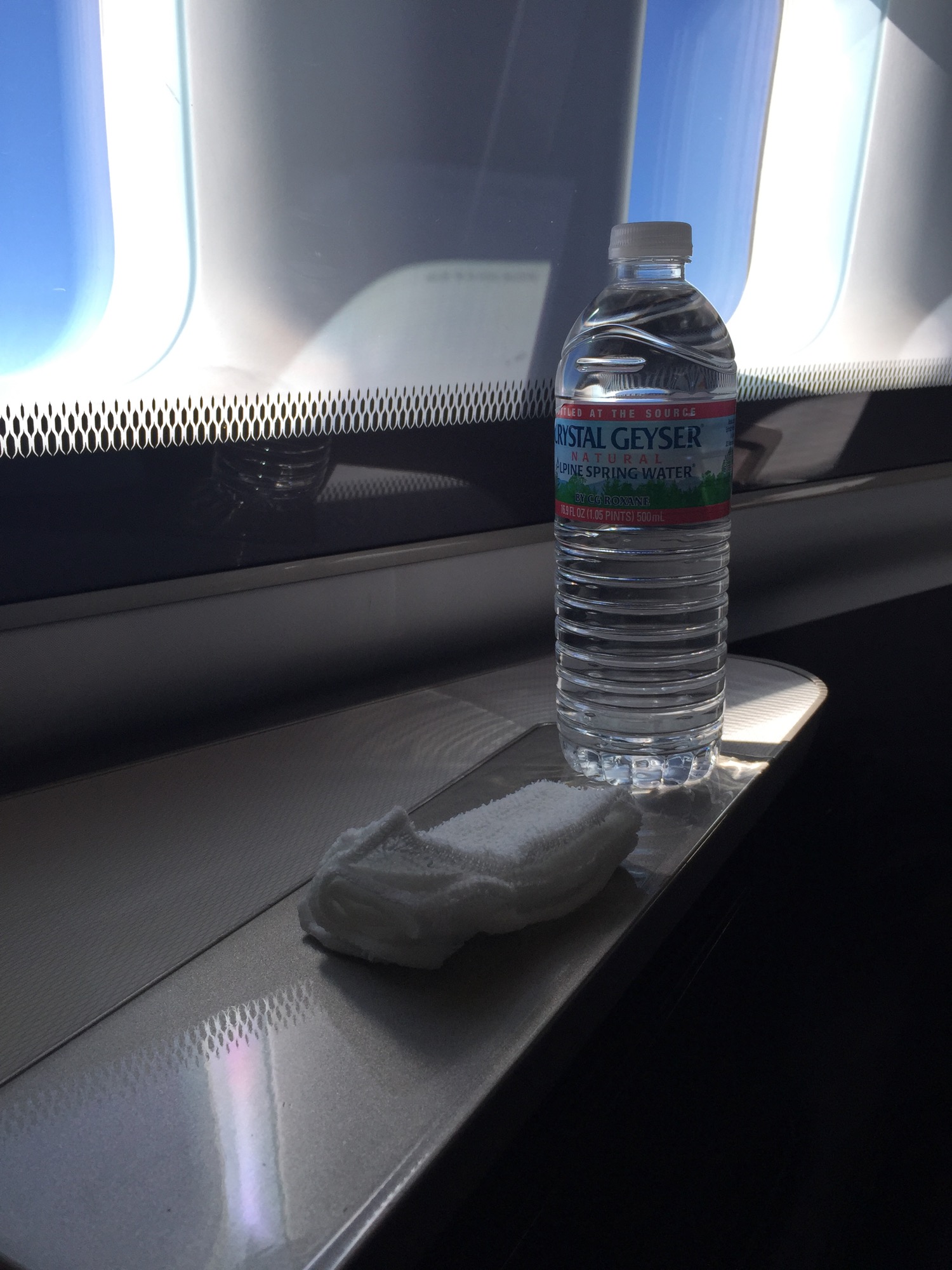 a bottle of water and a towel on a table