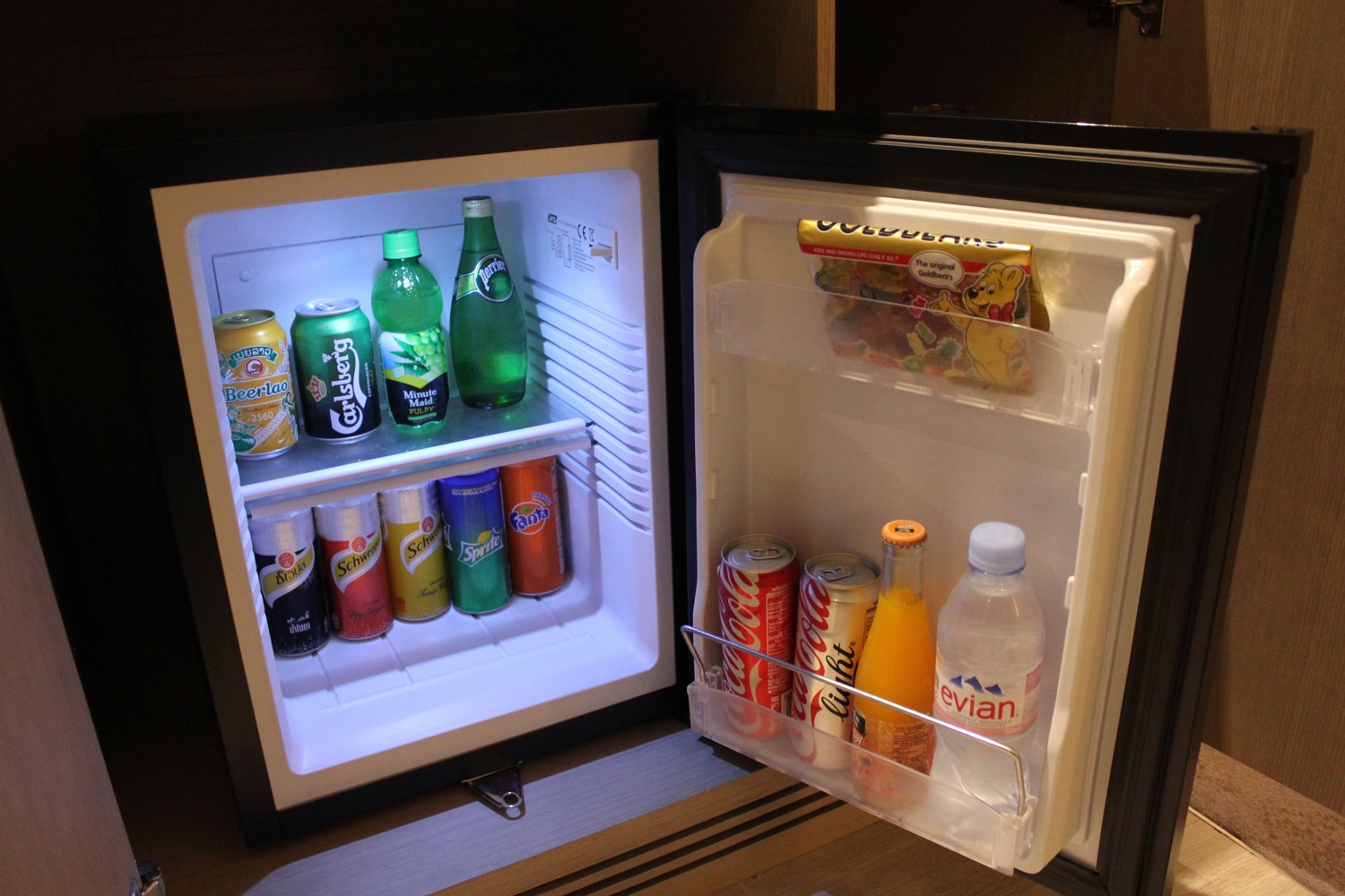 a mini fridge with drinks and snacks