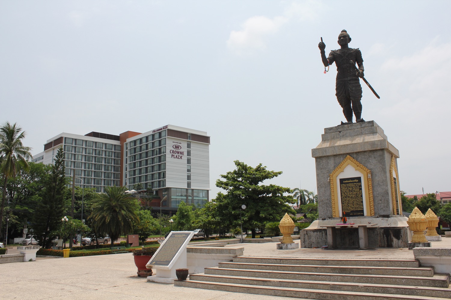 a statue of a man with a spear in front of a building