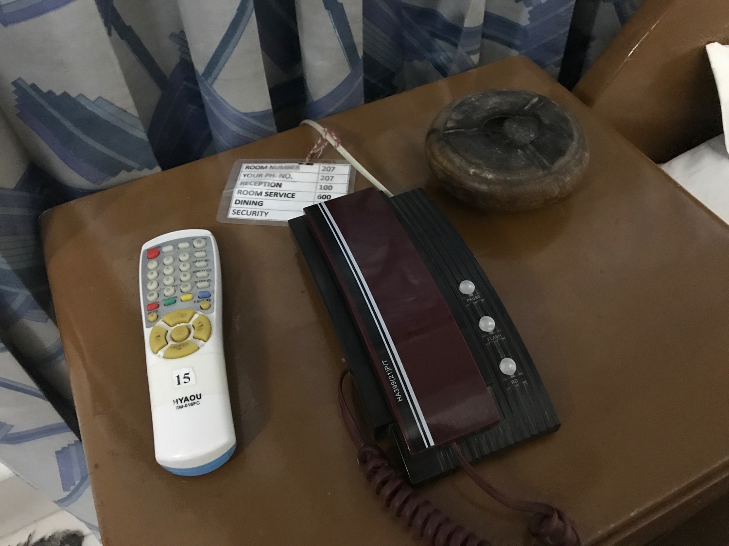 a telephone and a remote on a table