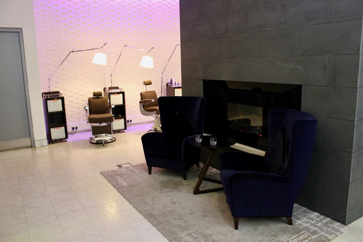 a room with chairs and a fireplace